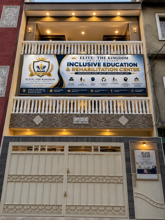Modern building at dusk with sign — Current Facility