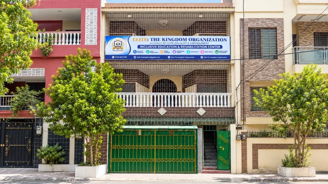 Widescreen building facade with blue-and-white sign — Current Facility